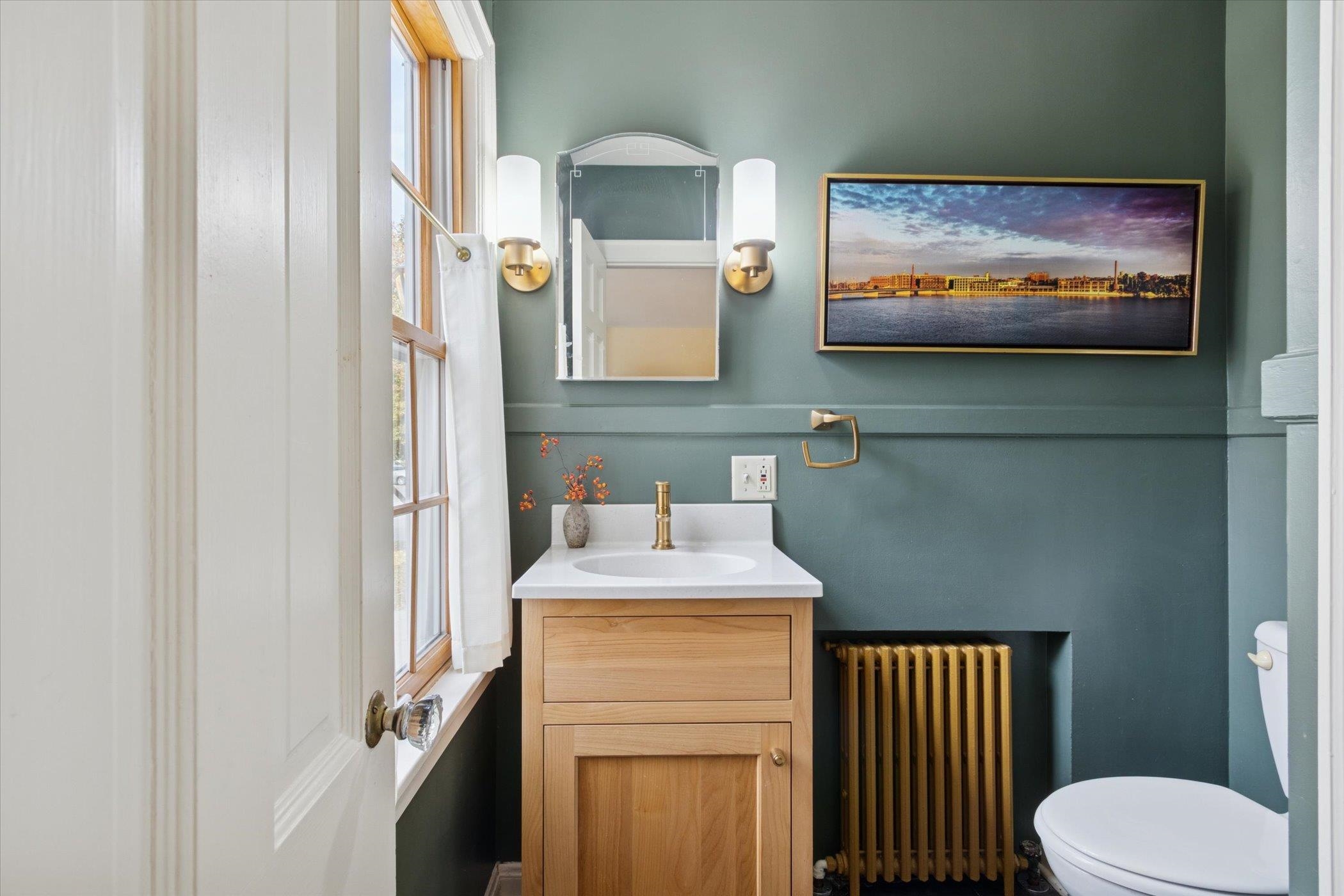 1408 Ave D Sterling, IL 61081 - Photo 41 of 56 a bathroom with a sink a mirror and a toilet