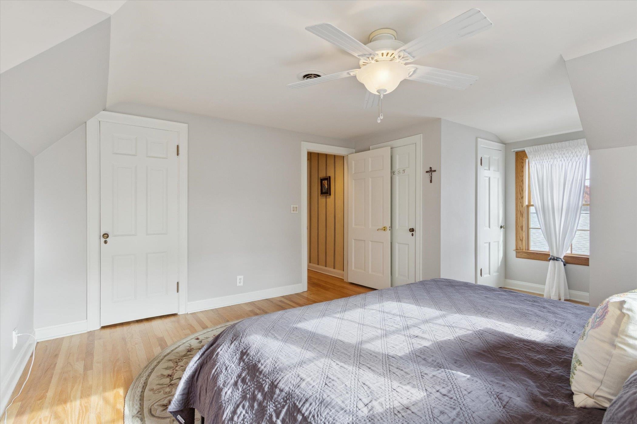 1408 Ave D Sterling, IL 61081 - Photo 52 of 56 a bedroom with a large bed closet and a chandelier