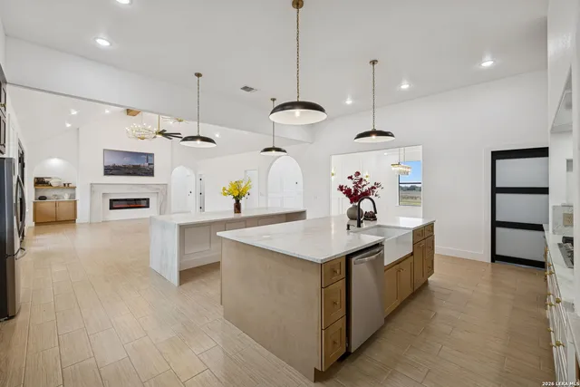 a dining room with furniture a chandelier and wooden floor
