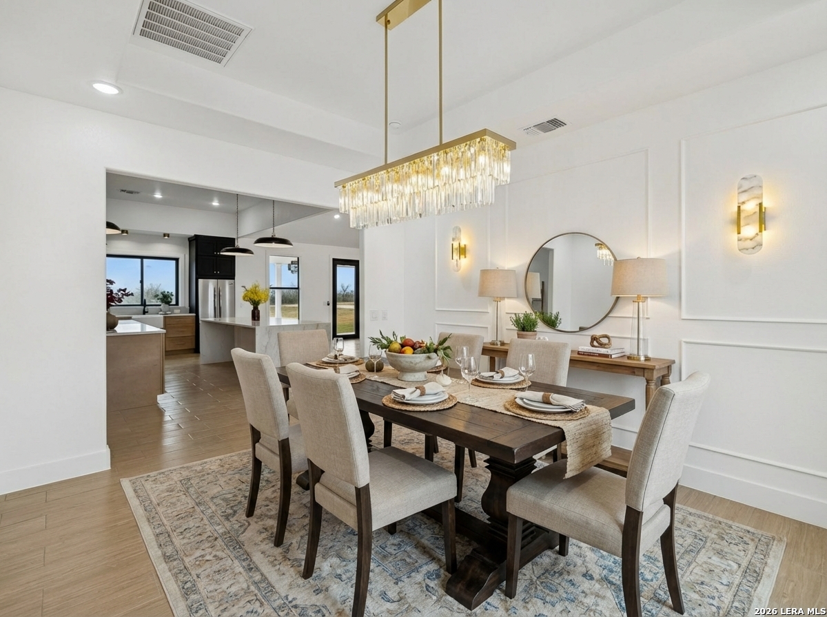 191 Hidden Ranch Court Floresville, TX 78114 - Photo 15 of 38 a view of a dining room with furniture and chandelier