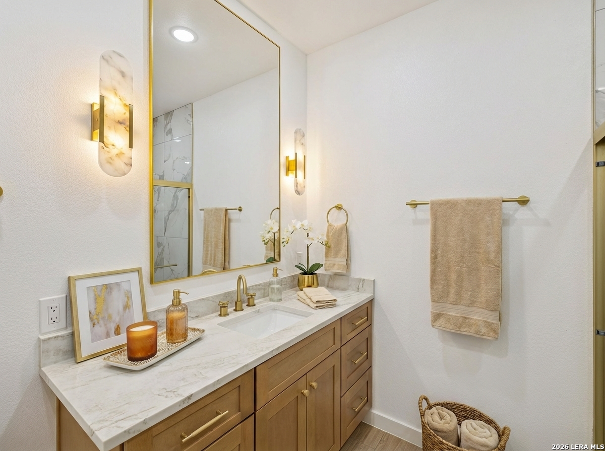 191 Hidden Ranch Court Floresville, TX 78114 - Photo 27 of 38 a bathroom with a sink and a mirror