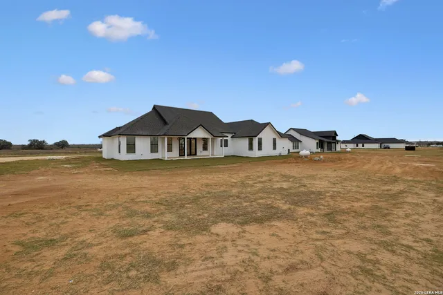 an aerial view of a residential houses with outdoor space