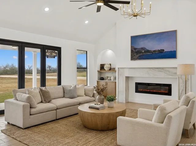 a living room with furniture a fireplace and a flat screen tv
