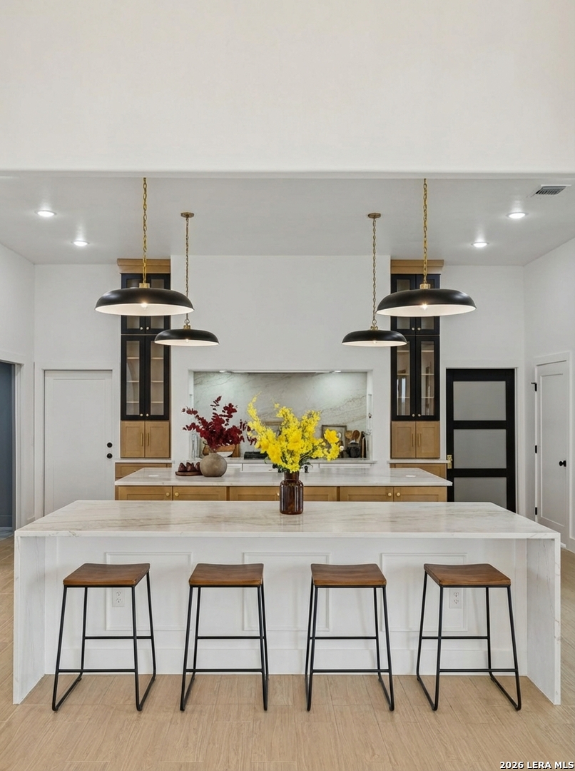 191 Hidden Ranch Court Floresville, TX 78114 - Photo 7 of 38 a kitchen with stainless steel appliances kitchen island a table and chairs in it