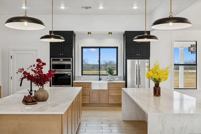 a kitchen with stainless steel appliances granite countertop a sink dishwasher and a refrigerator
