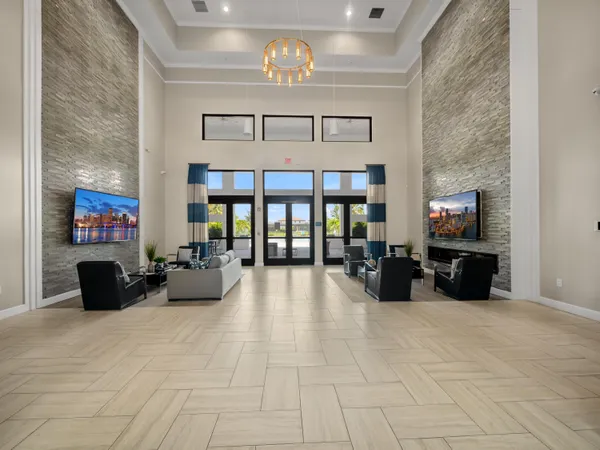 a living room with furniture and large windows