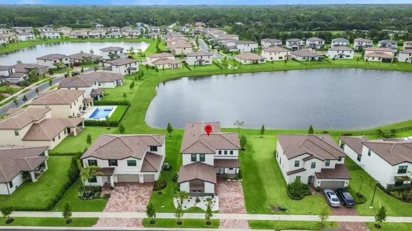 an aerial view of a house with a lake view