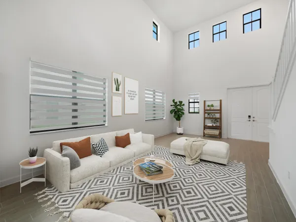 a living room with furniture and next to a window