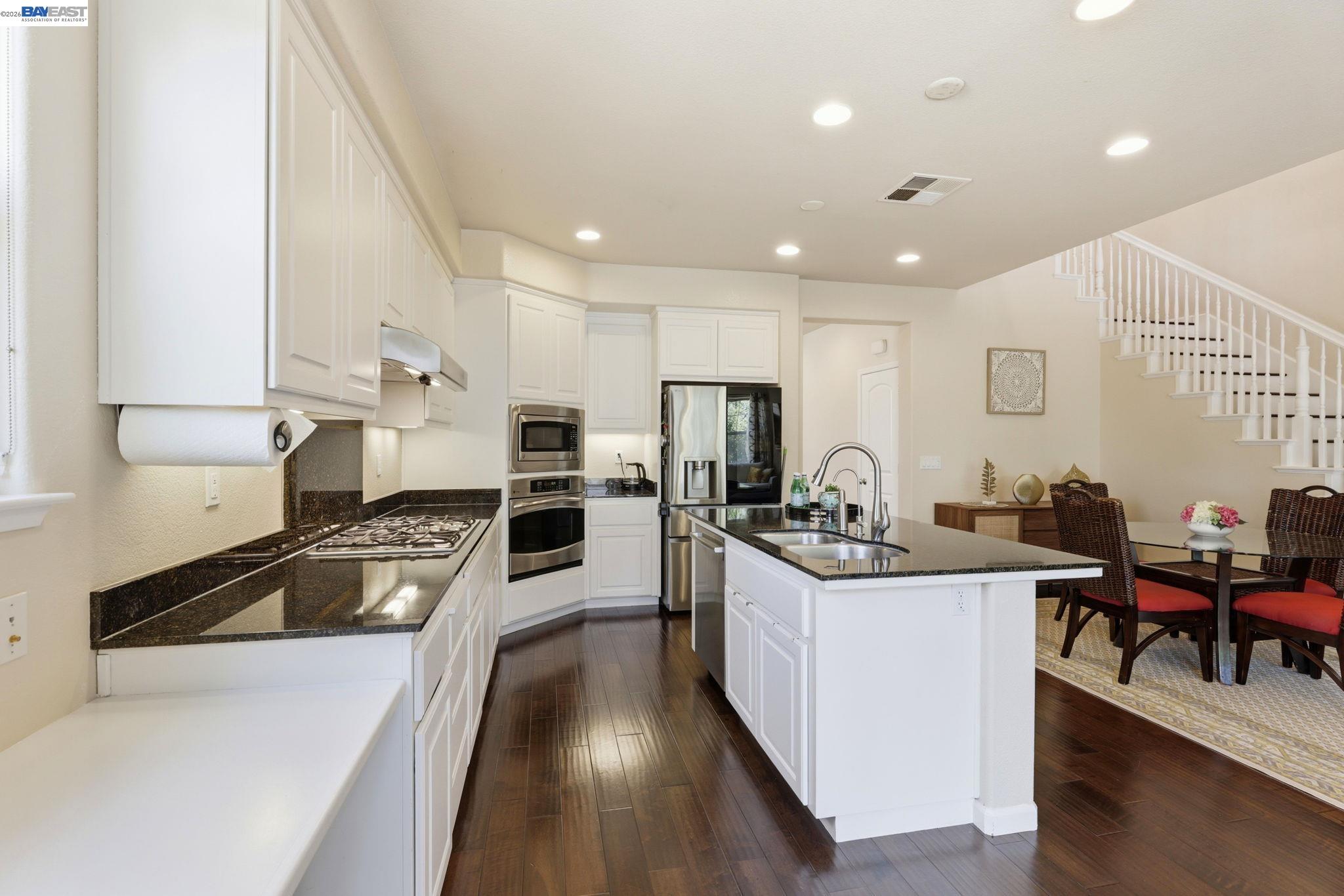 5029 Queensbury Way San Ramon, CA 94582 - Photo 11 of 58 a kitchen with stainless steel appliances kitchen island granite countertop a stove and a refrigerator