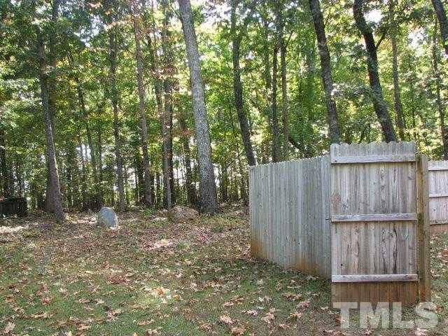 7821 McKee Road Rougemont, NC 27572 - Photo 6 of 25 a backyard of a house with lots of green space and wooden fence
