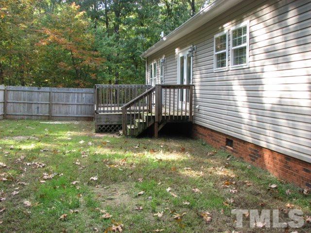 7821 McKee Road Rougemont, NC 27572 - Photo 7 of 25 a view of a backyard with a small cabin
