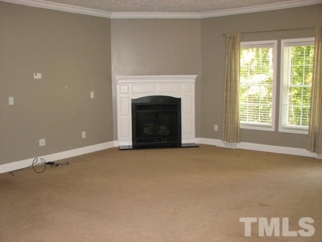 7821 McKee Road Rougemont, NC 27572 - Photo 9 of 25 a view of an empty room with a fireplace and a window
