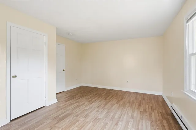 an empty room with wooden floor