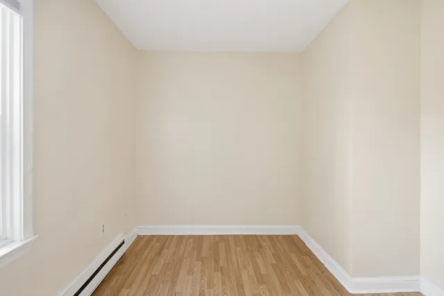 a view of wooden floor in a small bathroom
