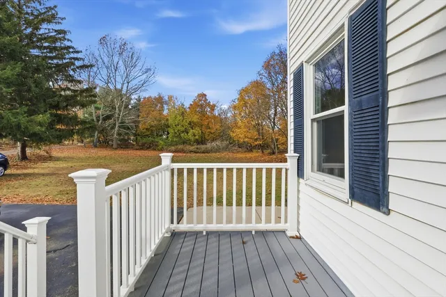 a view of a wooden deck with a yard
