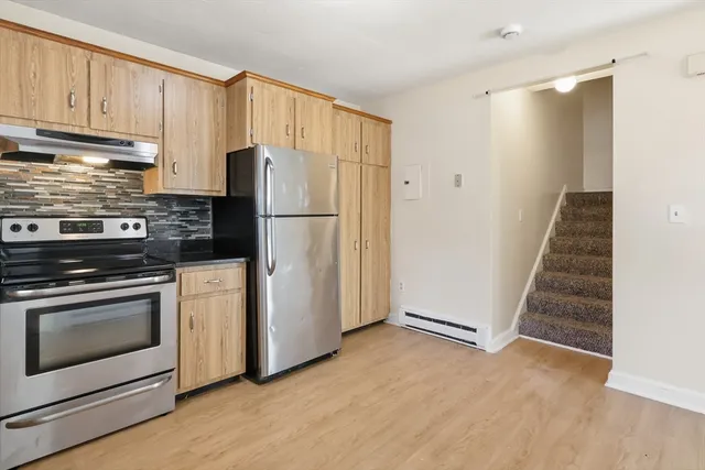 a kitchen with cabinets and stainless steel appliances