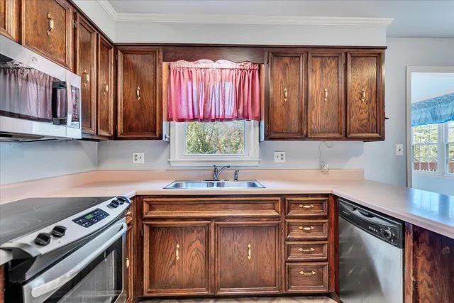 an empty room with windows and ceiling fan