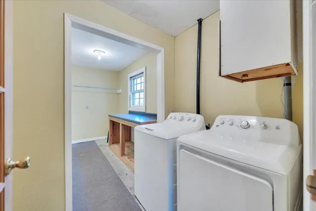 an empty room with windows and ceiling fan