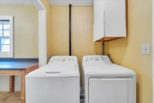 an empty room with a window and a ceiling fan