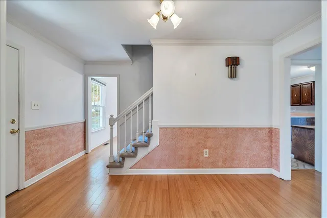 a view of empty room with wooden floor