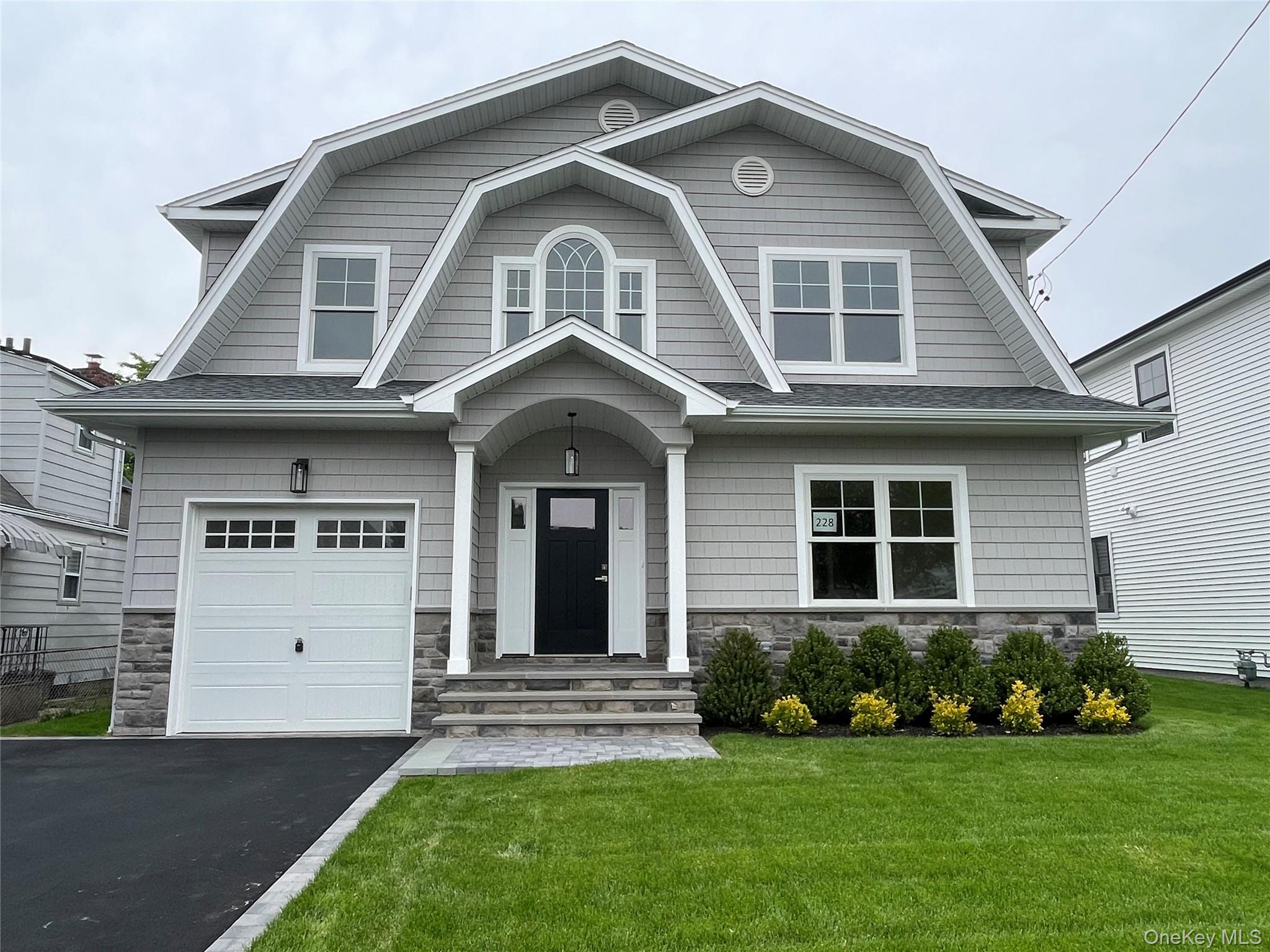 477 Andrews Road, Unit LOT A Mineola, NY 11501 - Photo 1 of 21 a front view of a house with a yard