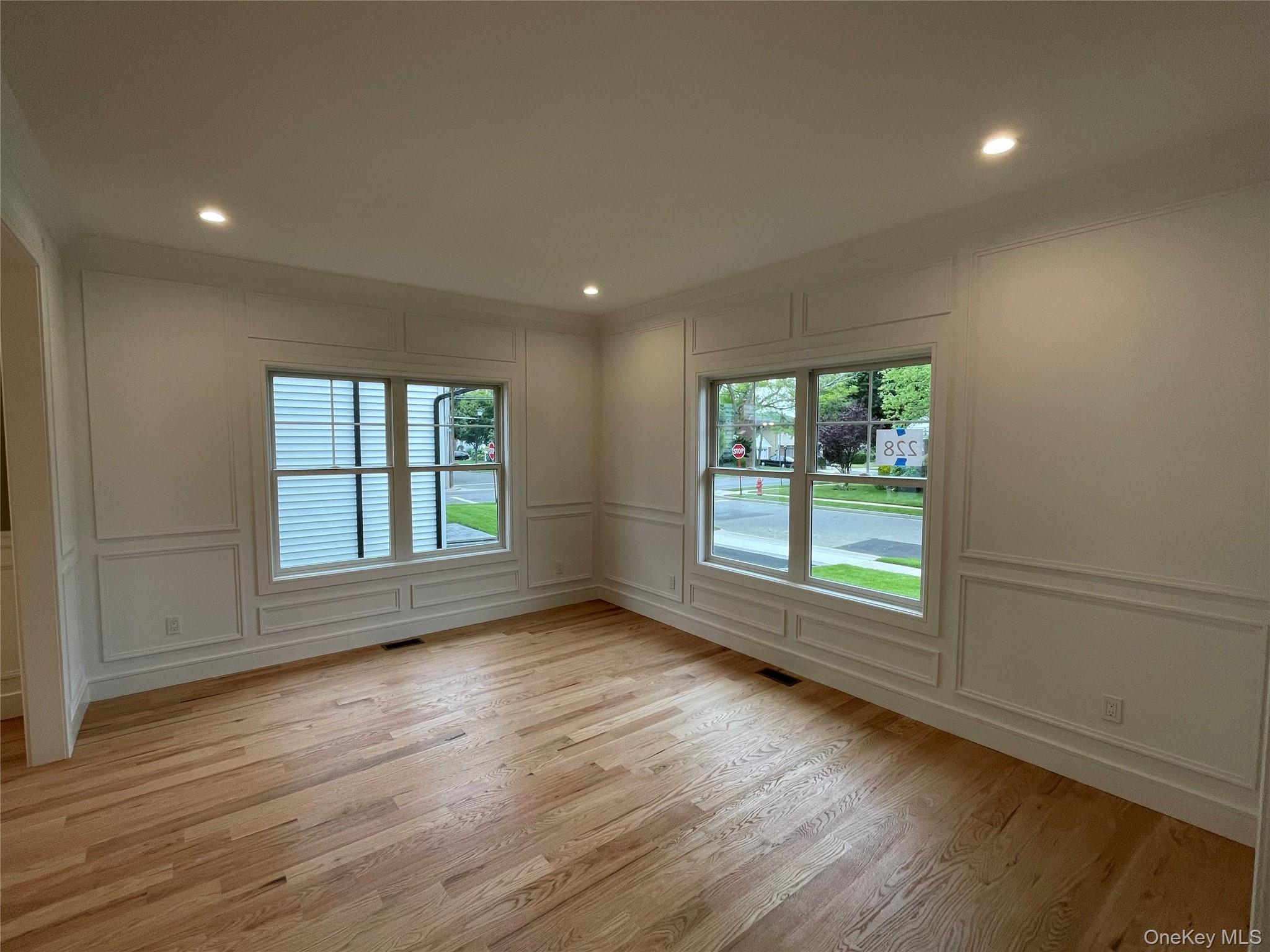 477 Andrews Road, Unit LOT A Mineola, NY 11501 - Photo 12 of 21 an empty room with wooden floor and windows