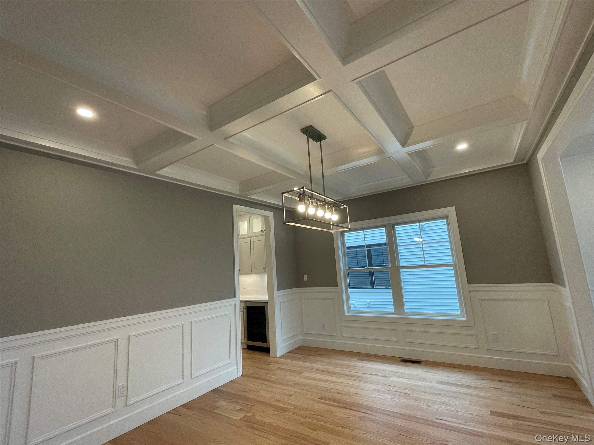 477 Andrews Road, Unit LOT A Mineola, NY 11501 - Photo 13 of 21 a view of an empty room with wooden floor and a window