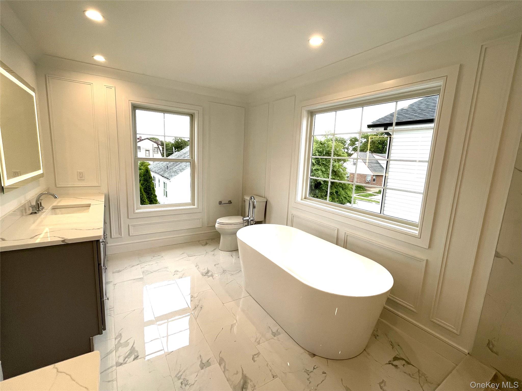 477 Andrews Road, Unit LOT A Mineola, NY 11501 - Photo 15 of 21 a bathroom with a bathtub sink and mirror