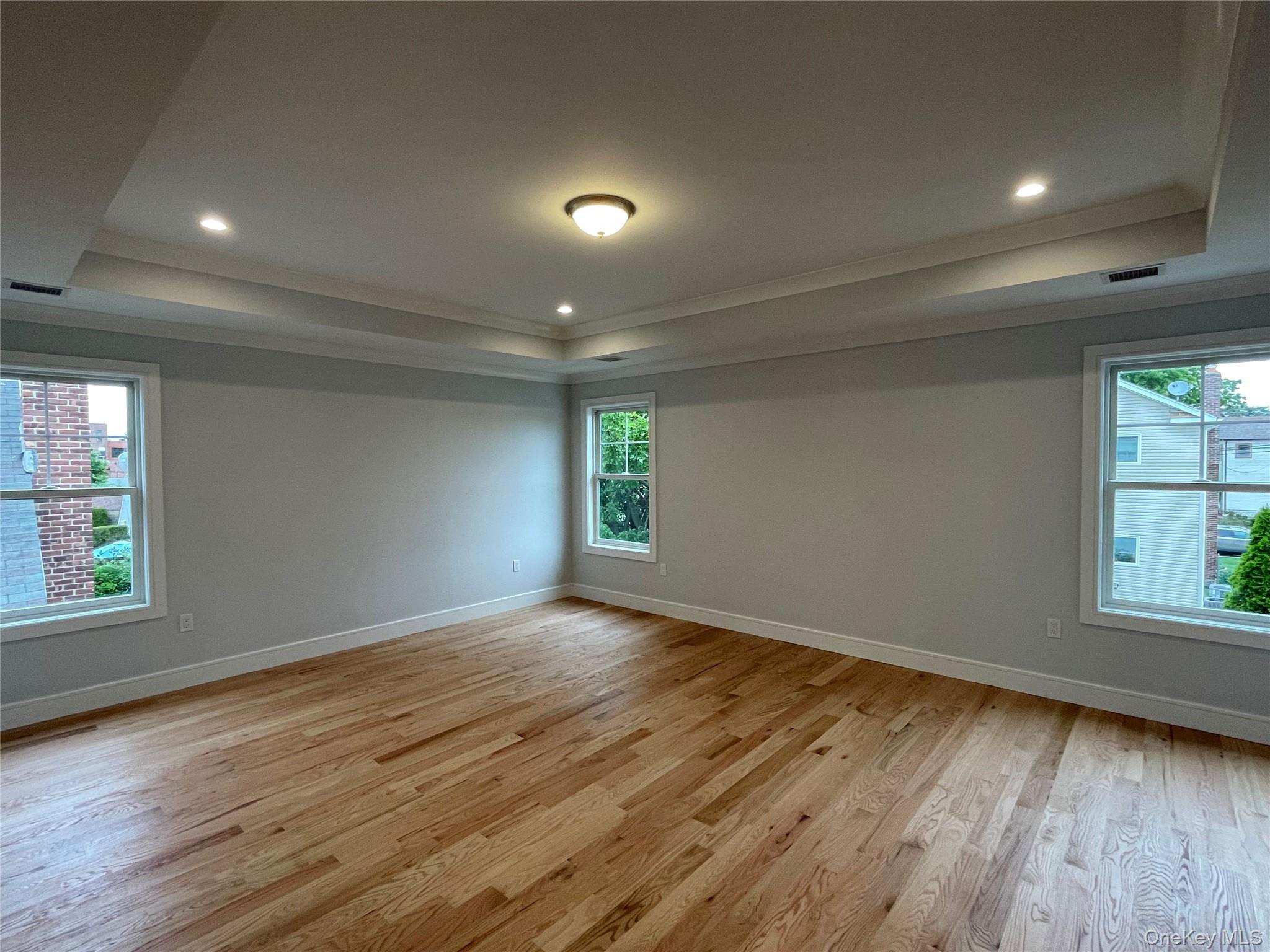 477 Andrews Road, Unit LOT A Mineola, NY 11501 - Photo 17 of 21 an empty room with wooden floor and windows