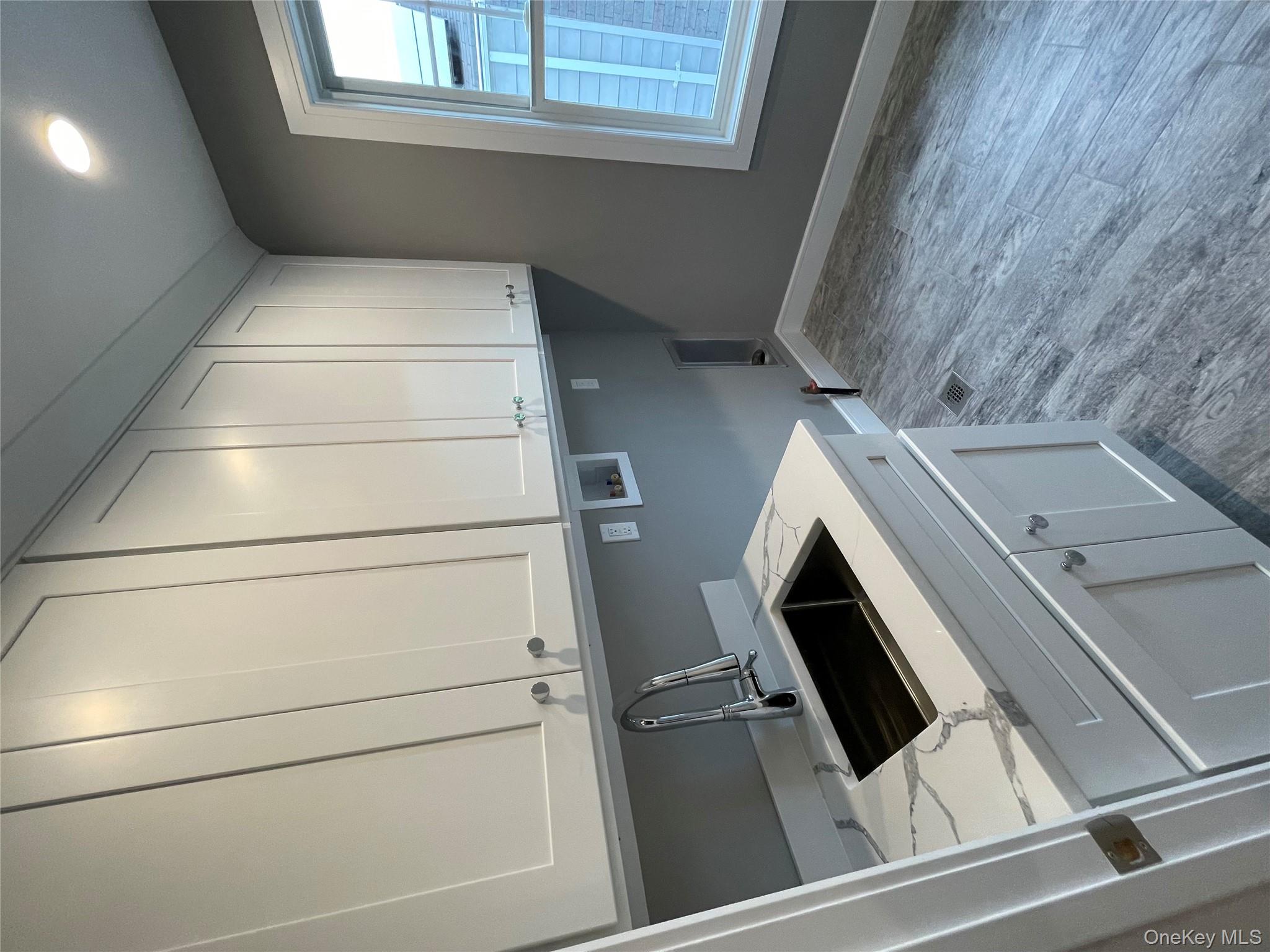 477 Andrews Road, Unit LOT A Mineola, NY 11501 - Photo 19 of 21 a kitchen with a sink and cabinets