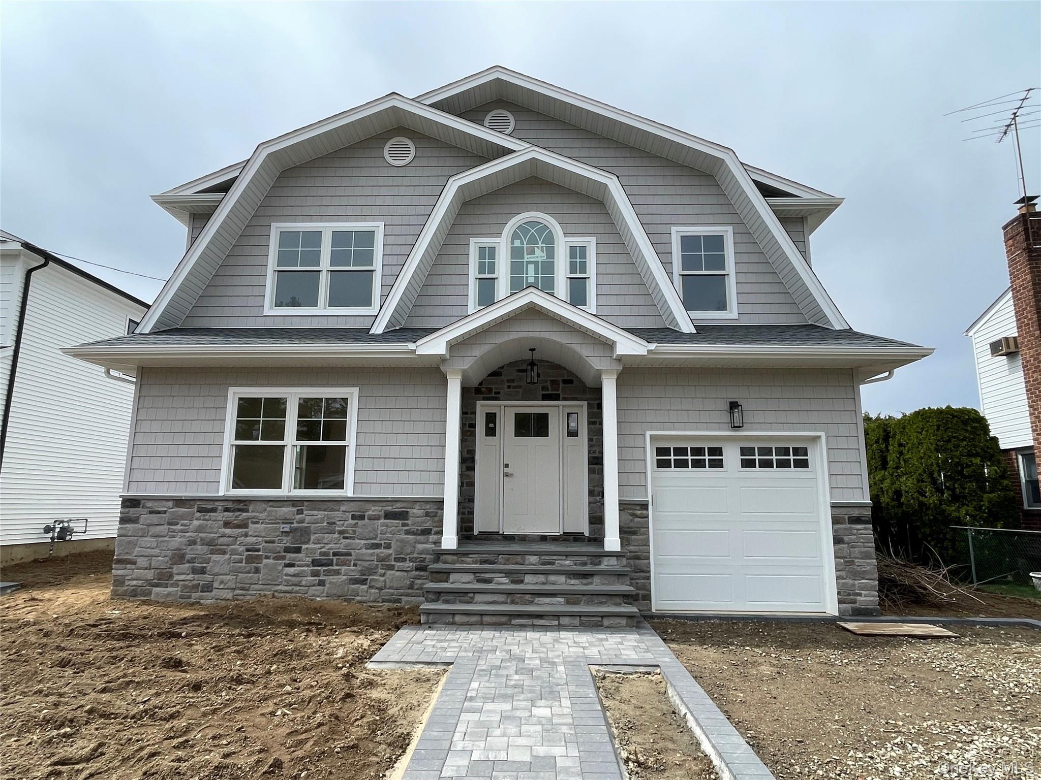 477 Andrews Road, Unit LOT A Mineola, NY 11501 - Photo 20 of 21 a front view of a house with a yard