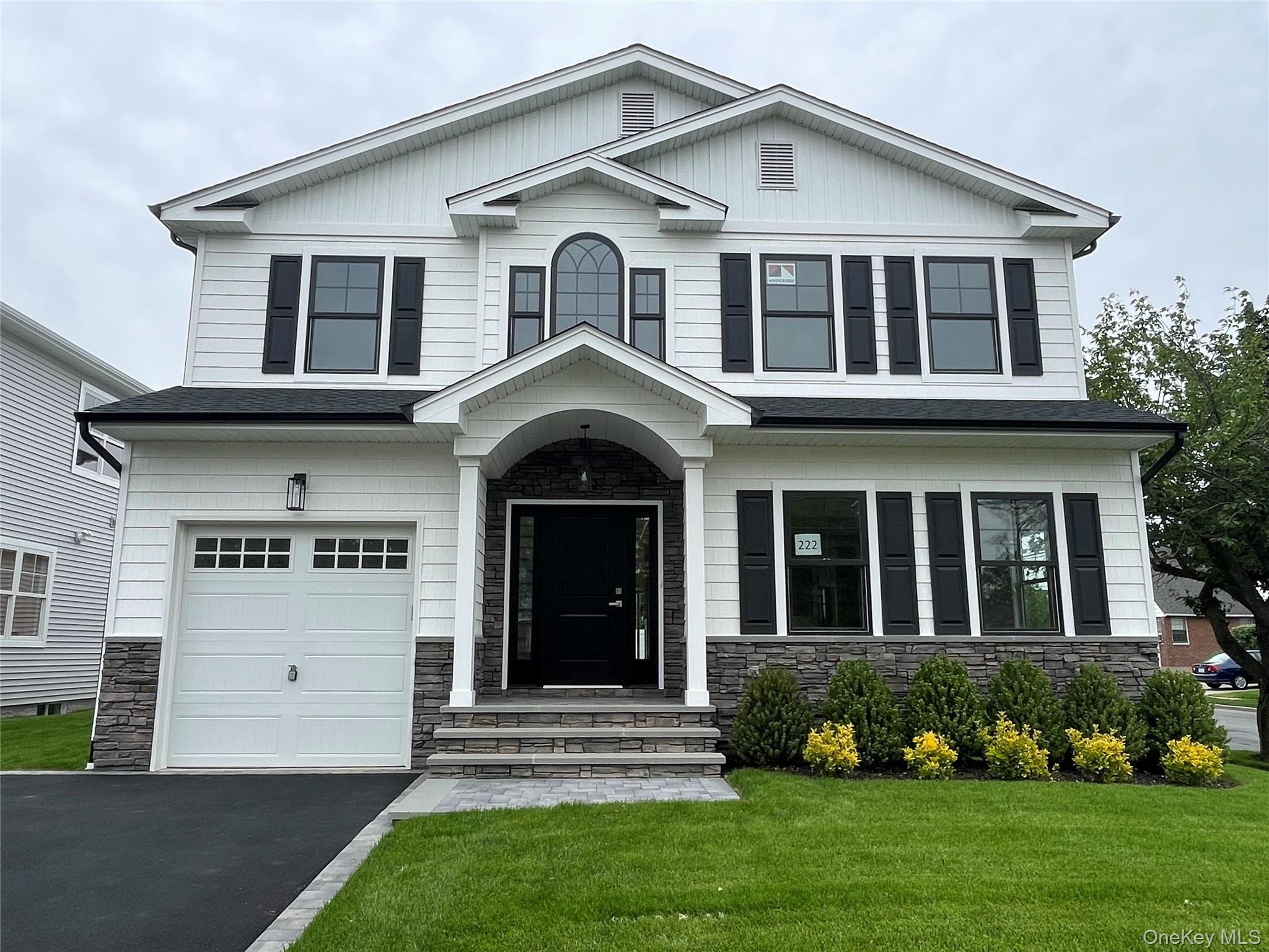 477 Andrews Road, Unit LOT A Mineola, NY 11501 - Photo 2 of 21 a front view of a house with a yard