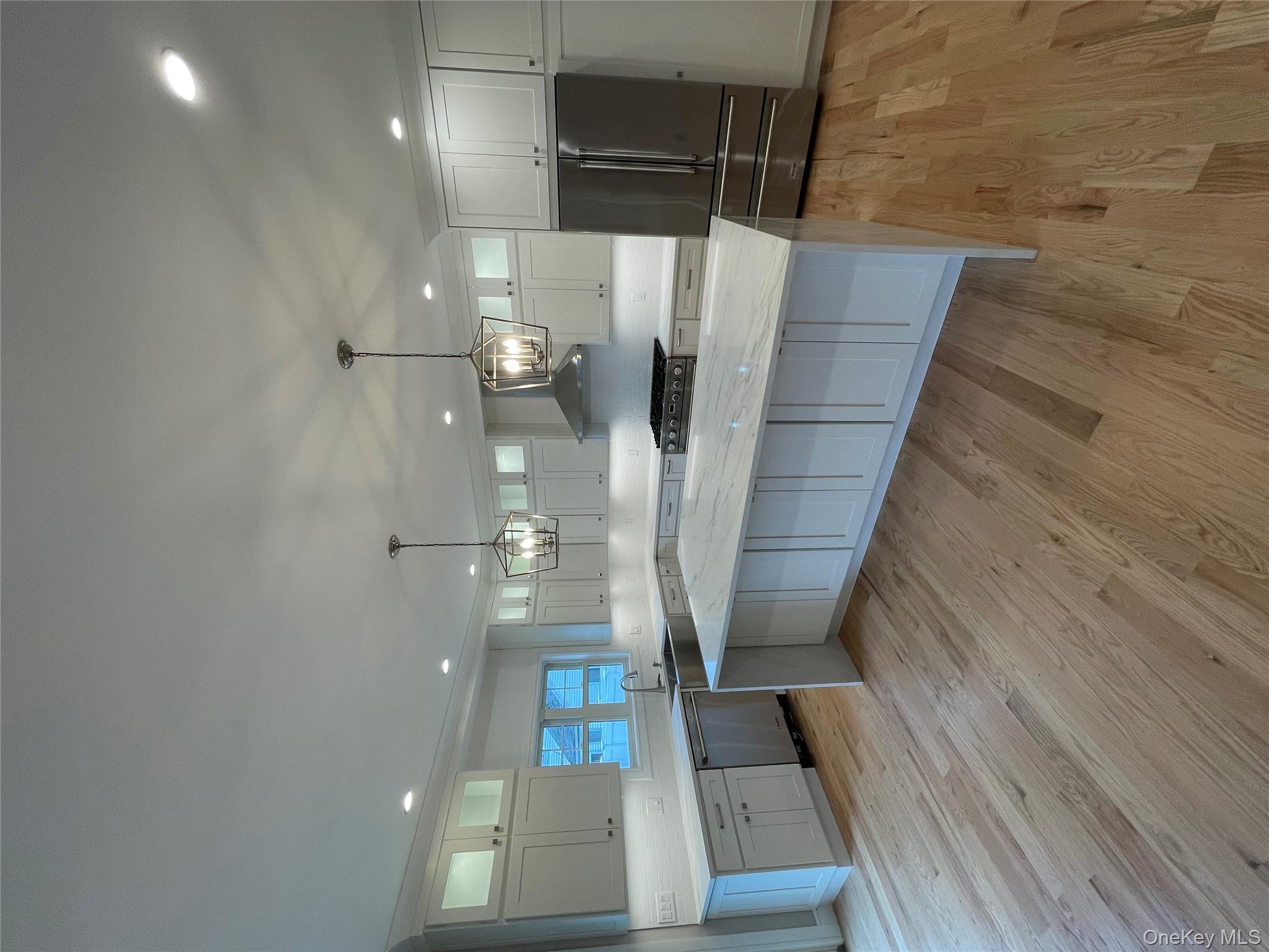 477 Andrews Road, Unit LOT A Mineola, NY 11501 - Photo 4 of 21 a large kitchen with a lot of counter space and wooden floor