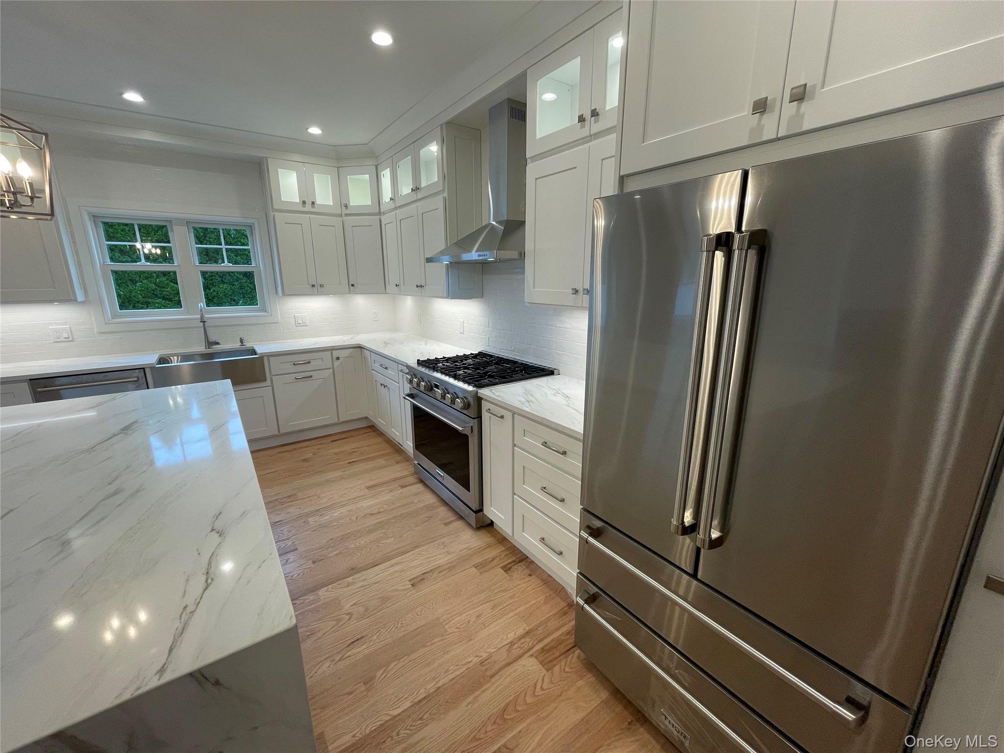 477 Andrews Road, Unit LOT A Mineola, NY 11501 - Photo 7 of 21 a kitchen with stainless steel appliances granite countertop a refrigerator and a sink