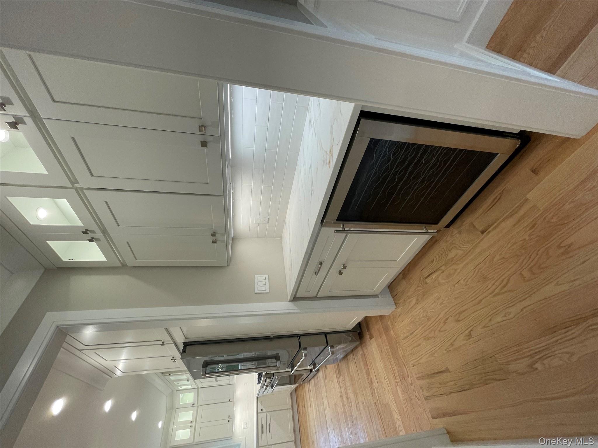 477 Andrews Road, Unit LOT A Mineola, NY 11501 - Photo 8 of 21 a kitchen with stainless steel appliances a stove and a refrigerator
