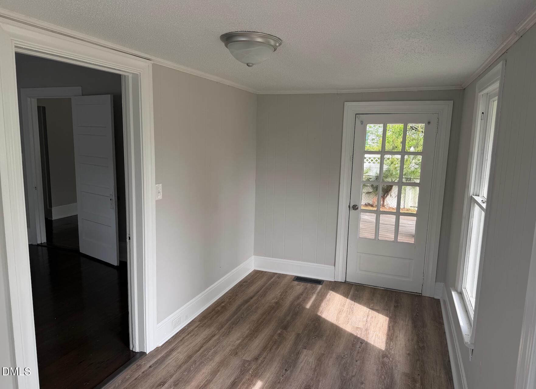 702 West Main Street Benson, NC 27504 - Photo 10 of 16 wooden floor in an empty room with a window