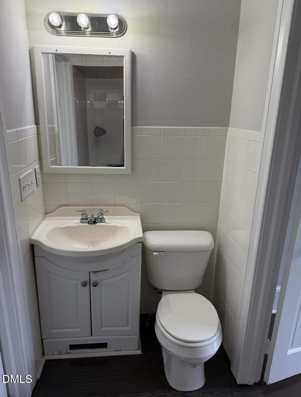 702 West Main Street Benson, NC 27504 - Photo 11 of 16 a bathroom with a sink toilet and mirror