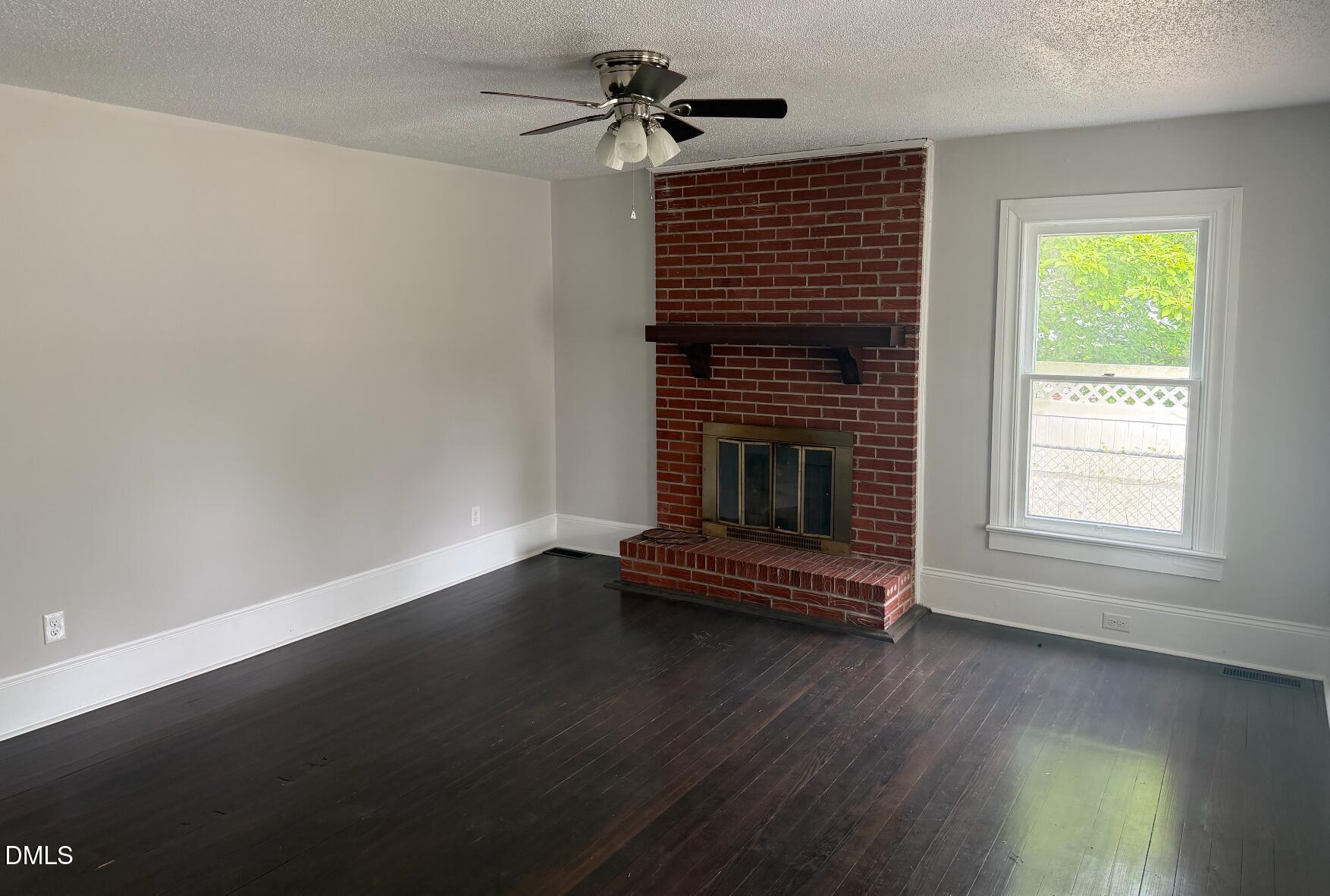 702 West Main Street Benson, NC 27504 - Photo 4 of 16 a view of empty room with wooden floor and fan