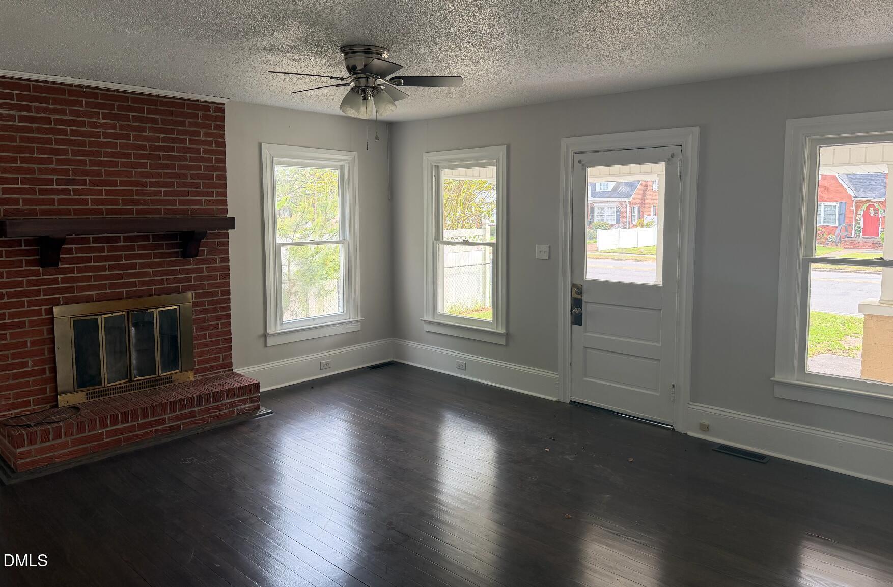 702 West Main Street Benson, NC 27504 - Photo 5 of 16 a view of an empty room with wooden floor and a window
