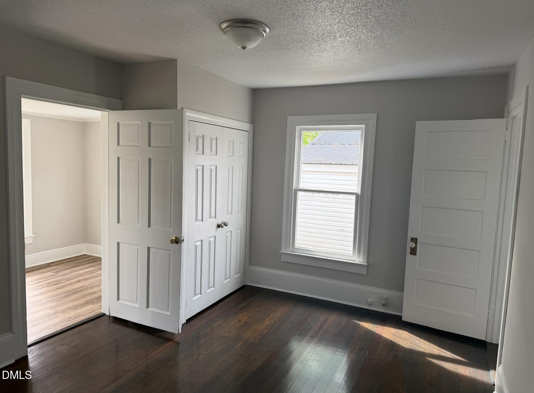 702 West Main Street Benson, NC 27504 - Photo 6 of 16 an empty room with wooden floor and windows