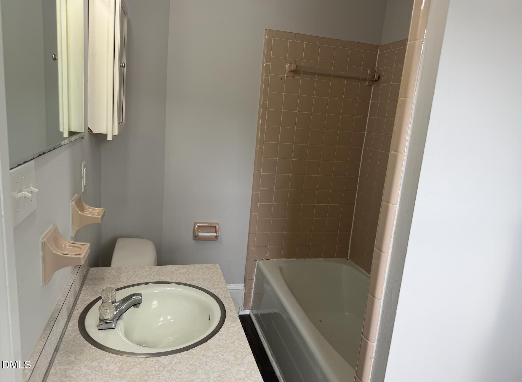 702 West Main Street Benson, NC 27504 - Photo 8 of 16 a bathroom with a sink a toilet and bathtub