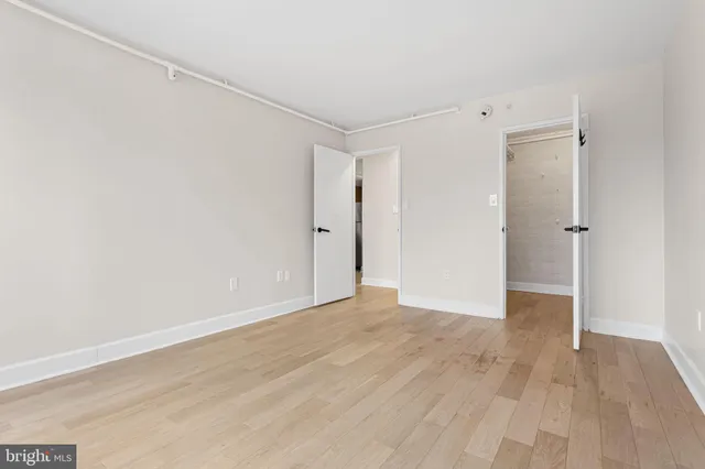 a view of an empty room with wooden floor