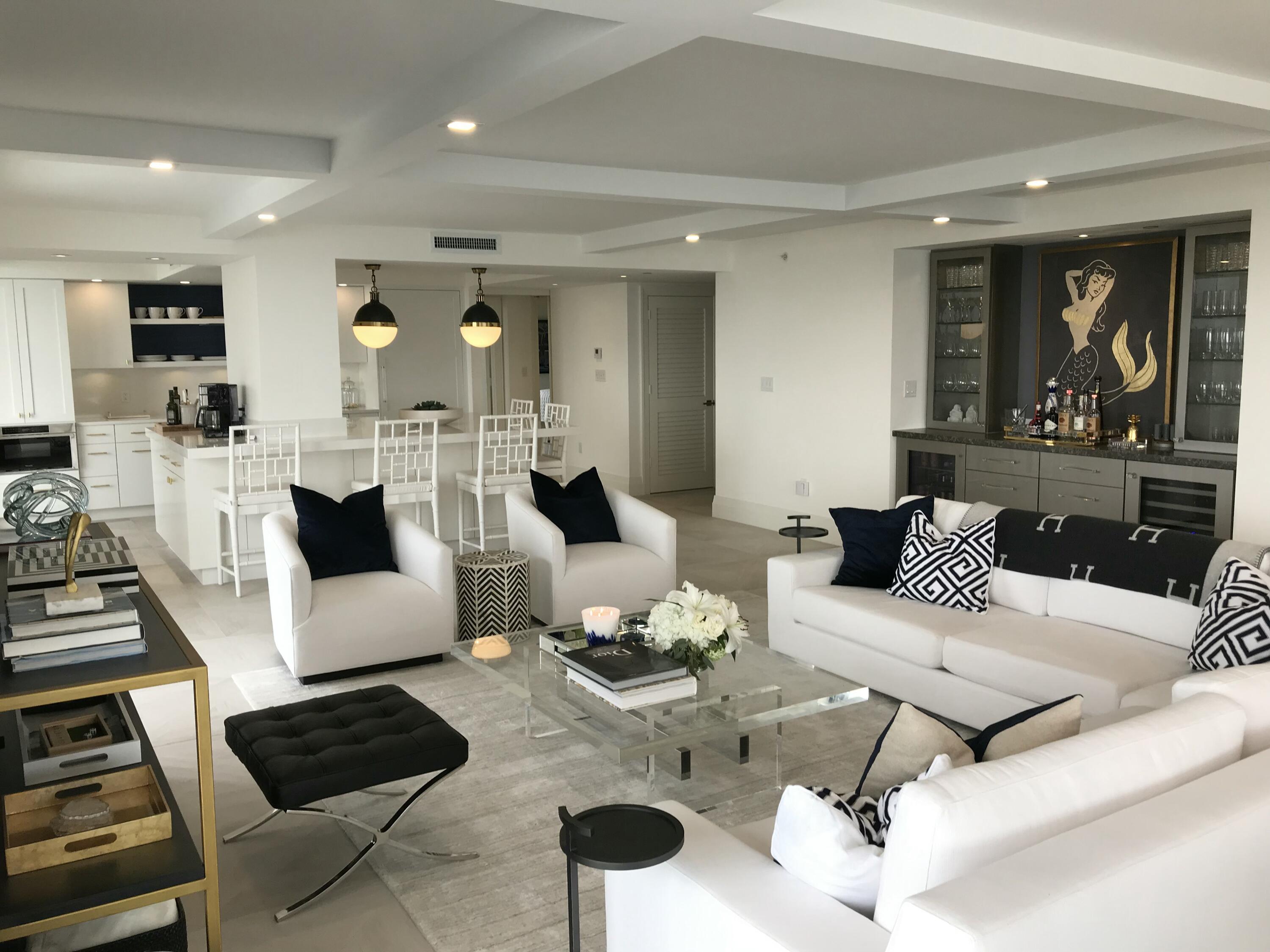 400 South Beach Road, Unit 504 Tequesta, FL 33469 - Photo 7 of 22 a living room with furniture a rug and a chandelier