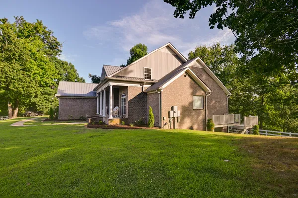 a view of a dining room with furniture a chandelier and wooden floor