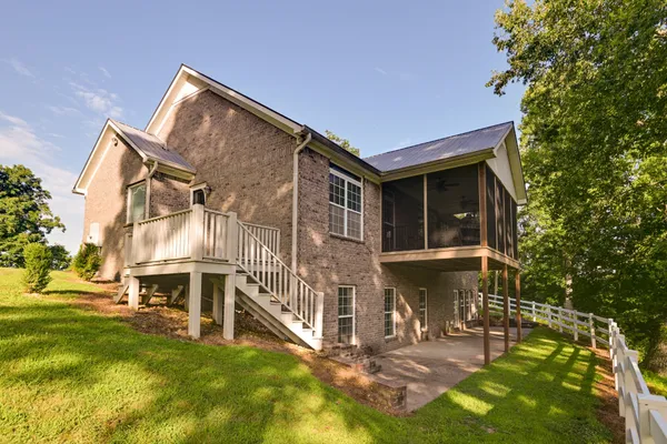 a living room with furniture fireplace and a large window