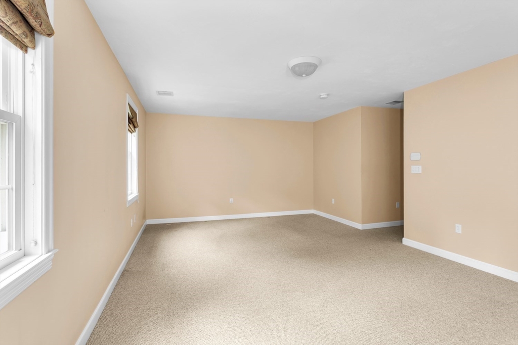 49 Beaver Street, Unit 49 Franklin, MA 02038 - Photo 17 of 46 a view of an empty room with a window