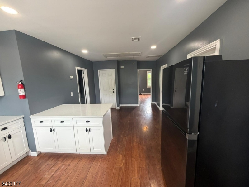 166 Renner Avenue, Unit 3 Newark, NJ 07112 - Photo 7 of 24 a large white kitchen with wooden floor