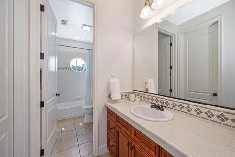 a view of a patio with a table and chairs under an umbrella