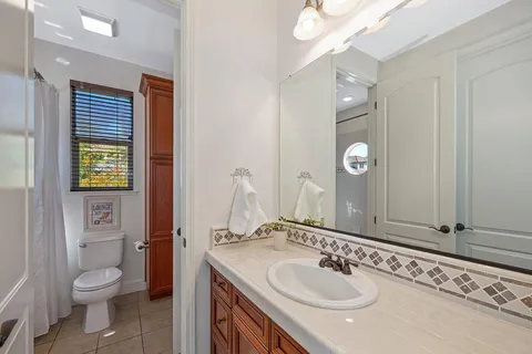 a wooden bench sitting in the middle of a backyard