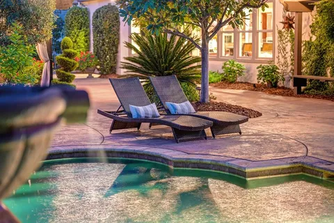a view of a backyard with wooden fence
